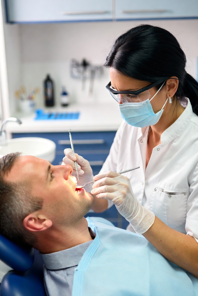 Happy patient relaxing in dental chair at Quality Raleigh Dental Care