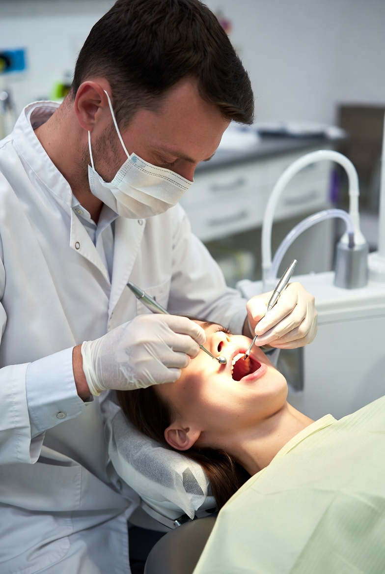 Dentist providing emergency dental care to a patient in Raleigh NC